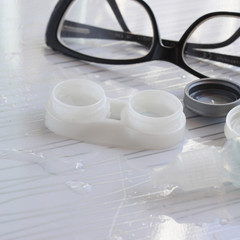 Contact lenses in container, bottle with solution, glasses - 337760556