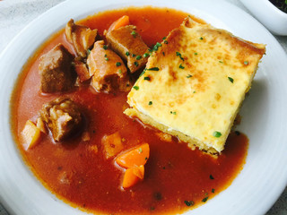 red soup with meat and cheese