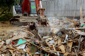 Loaded dumpster with excavator loads construction waste
