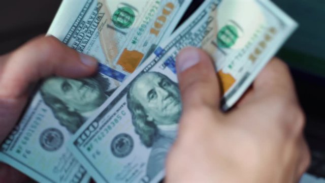 Crop successful businessman counting hundred dollar bills