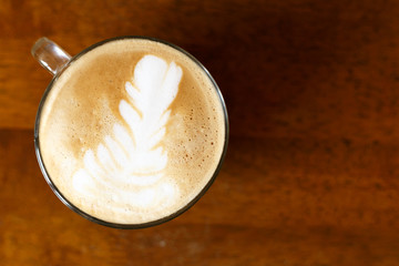 A cup of cappuccino with a beautiful pattern. Latte art
