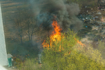 Fototapeta na wymiar Wildfire near houses, view from the apartment window