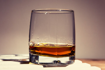 Glass of whiskey on an old wooden table
