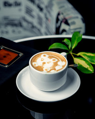 a cup of latte with latte art with bear print