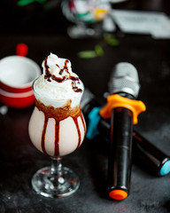 a glass of cacao cocktail with chocolate syrup and whipped cream