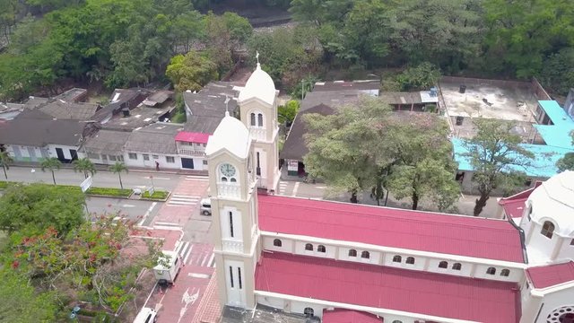 Church in the town of Restrepo / Colombia, with vegetation close to the population, Catholic belief, Aerial drone video.