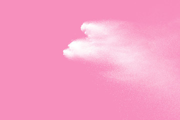White powder explosion on pink background. Paint Holi.