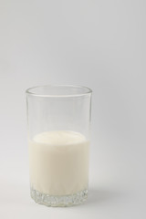 Kefir drink in a bottle and glass on a white background.Sour milk drink
