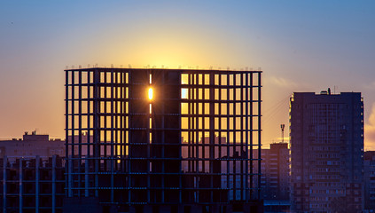 Rays of light breaking trough the opening of an unfinished house.