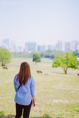 earth day and protect environment activity from backside of woman see with sad feeling because city instread of the forest