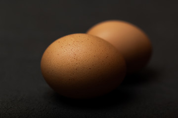 Eggs on black background,  selective focus, close up, deep shadows
