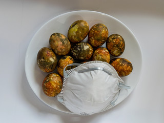 many bright and colorful Easter eggs and face mask