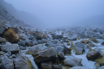 Rocky mountains in mist and fog