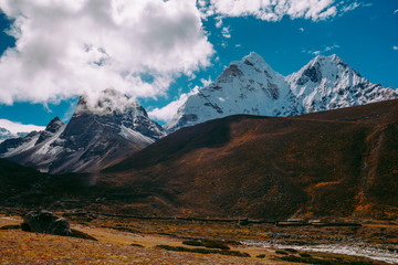 Snow covered beautiful mountain peaks and soft white clouds