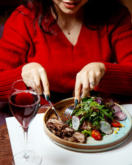 girl eating meat salad with onions