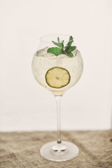 alcoholic cocktail with greens ice and lime