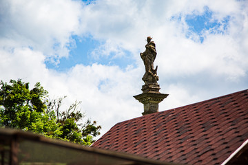 Statue on the roof against the blue sky