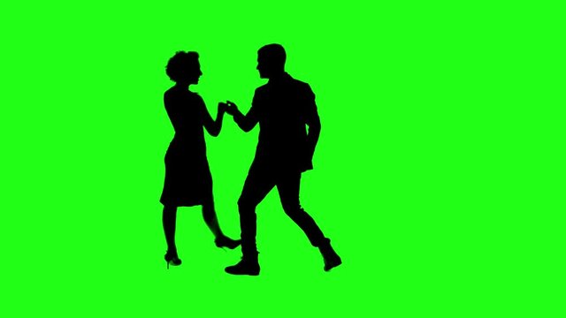 A Young couple dancing tango profesional dancers on Green Screen Silhouette Pair in spanish argentinian dress performs dance movement. 4K 60fps Argentina France Chroma key Argentina  Buenos Aires Mess