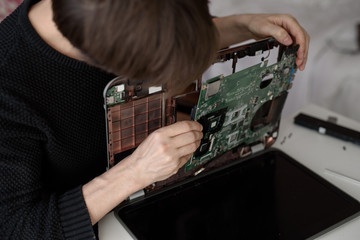 Laptop repair. Disassembled computer parts. PC electronic components. Closeup of keyboard, hdd, motherboard cpu