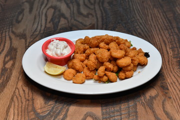 Crispy fried chicken bites with salad. Traditional american food.