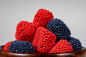 Fruit flavored gummy candies in wooden bowl