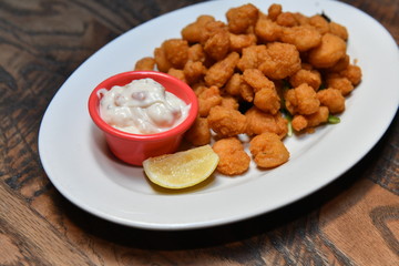 Crispy fried chicken bites with salad. Traditional american food.