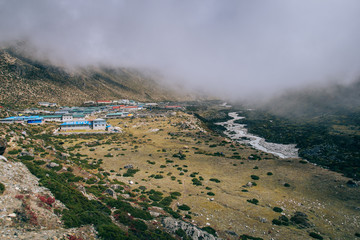 Mountain village and green fields