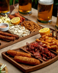 platter of beer snacks with fried cheese chicken sunflower seeds cheese and sausages