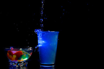 glass of waterglass, water, drink, splash, cocktail, liquid, alcohol, beverage, splashing, ice, martini, blue, cold, drop, fresh, isolated, bubble, pouring, wet, white, cool, bar, object, black, vodka