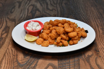Crispy fried chicken bites with salad. Traditional american food.