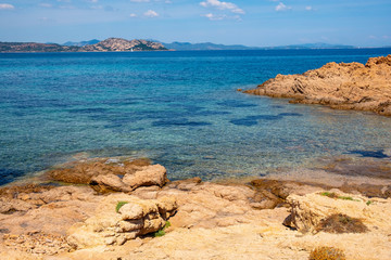 Panoramic view of Spalmatore di Terra peninsula of Marine Protected Area natural reserve with seashore rocks of Isola Tavolara island on Tyrrhenian Sea off northern coast of Sardinia, Italy