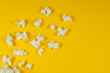 Salted popcorn on a yellow background close-up. View from above.