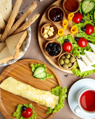 top view of breakfast setup with omelette tea cup and other dishes