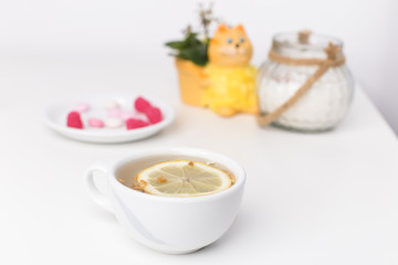 tea with lemon and raspberries on the table