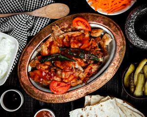 top view of chicken kebab garnished with tomato sauce