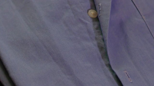 Open buttons of a blue shirt and colars