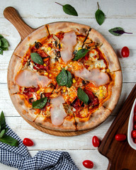 top view of ham pizza with corn tomato mozzarella mushroom and tomato sauce