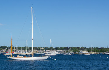 Newport harbor with two-masted sailing ship in foreground