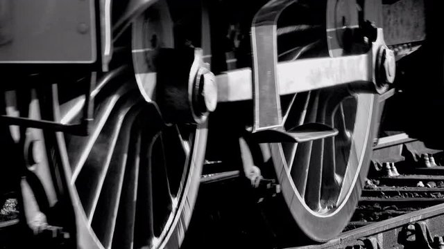 Steam train close up of wheels moving on track UK 4K