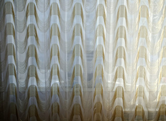 laptop on the windowsill behind the curtain