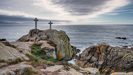 Two crosses on a rock at Cape Roncudo in La Coruña, Galicia, Spain.