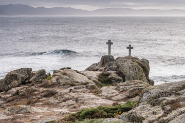 Fototapeta na wymiar Two crosses on a rock at Cape Roncudo in La Coruña, Galicia, Spain.