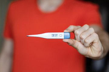 coronavirus danger COVID-19 epidemic outbreak quarantine concept of boy holding thermometer with high level of temperature