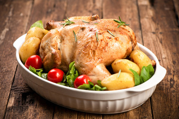 Roasted turkey garnished with potato and veg. Thanksgiving Christmas dinner. Chicken, roasted