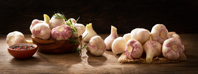 Fresh garlic bulbs with rosemary and pepper