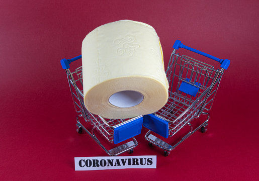 Consumer buying panic about coronavirus covid-19 concept. Toilet paper roll in shopping trolley with inscription stop panic. People are stocking up essentials for home quarantine