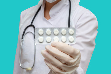 Female doctor showing pills in the hands of a close-up. The appointment of treatment.
