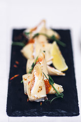 pancakes with fish filling, micro-greens and caviar