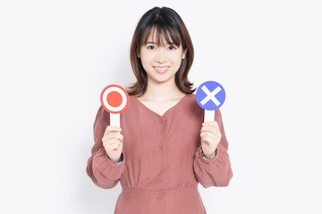 マルバツのプラカードを持つ女性