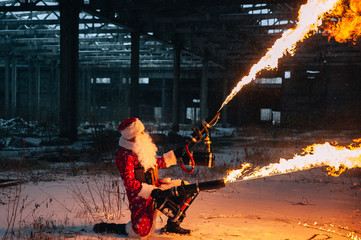 Santa Claus with flamethrowers in an abandoned warehouse
